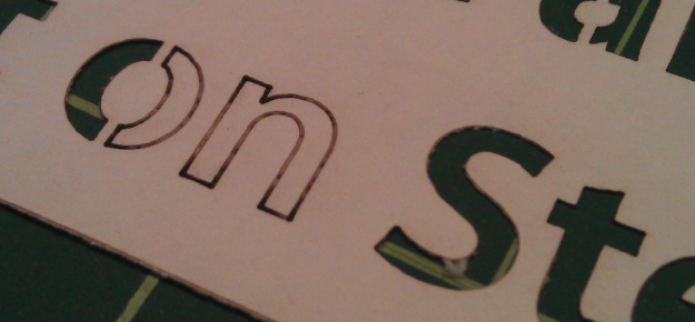 An example of some letters on card from a laser cutting that it didn't cut fully