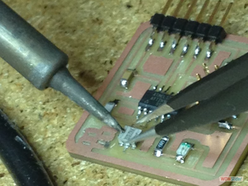 Kenzo helping to add the 20mHz resistor back onto the board