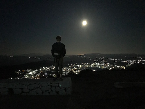 Greg standing above an island nightscape