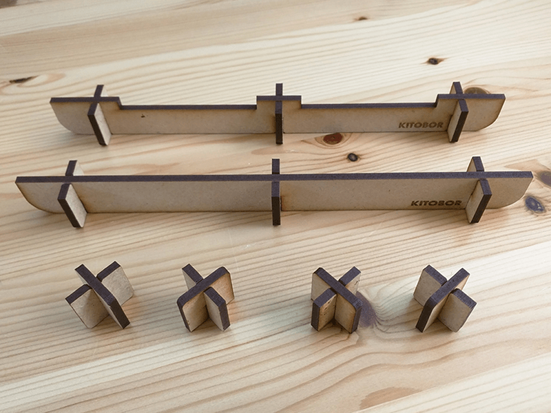 Laser-cut stand-offs for lifting material away from the laser bed.