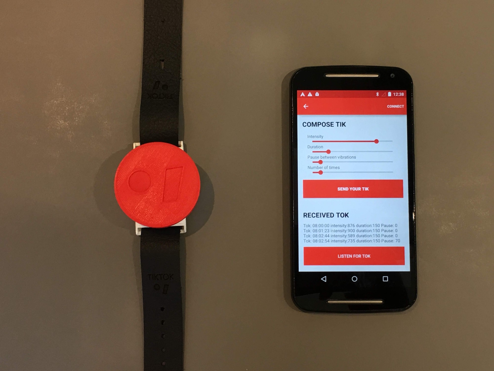 A Hero shot of my final project, a working TIKTOK band detecting taps, vibrating and communicating with the TIKTOK app via Bluetooth