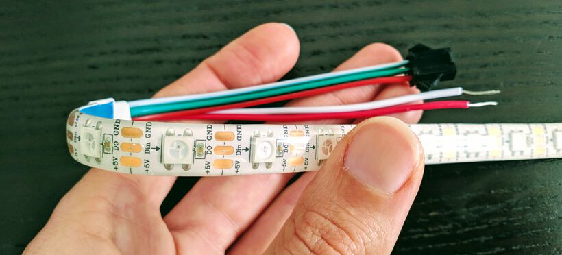 The NeoPixel strip has a 5V (red), DATA (green) and GND (white) connection