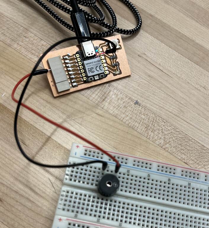 Circuit with an Arduino Uno and a buzzer on a breadboard