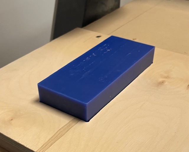 Wax block in wood holder on CNC machine