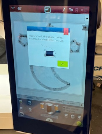 Message on embroidery machine asking to check upper thread