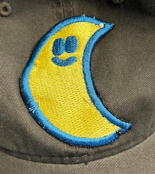 Moon pinned to baseball cap