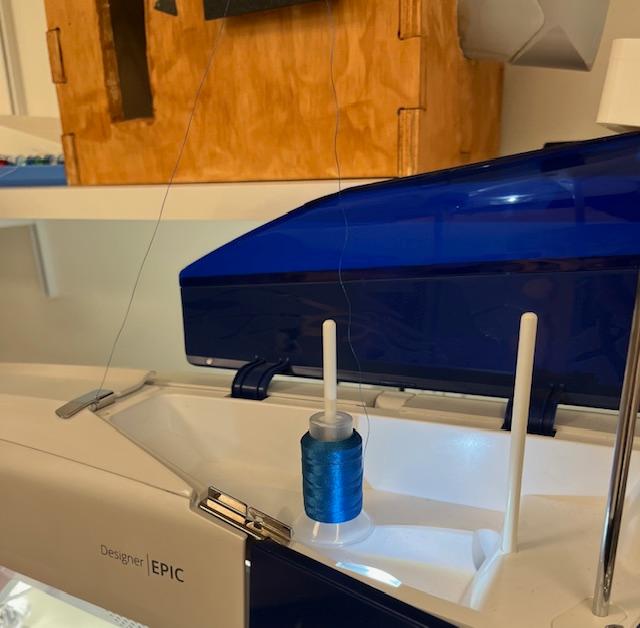 Spool of thread on embroidery machine