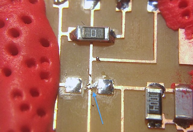 Solder that bridged again the pins