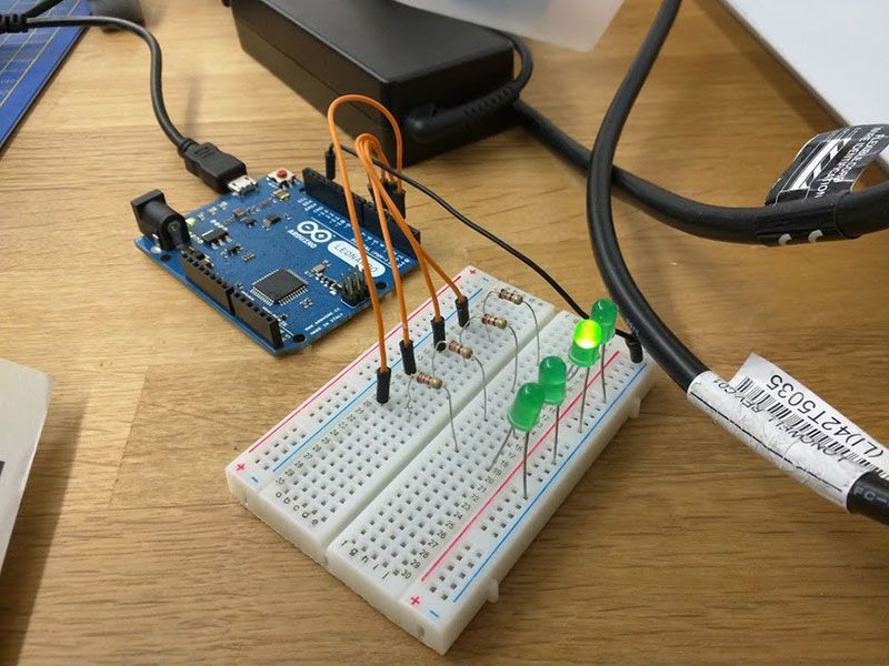 Breadboard showing four resistors and four LEDs connected to the Arduino.