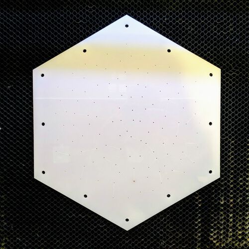 The cut out bottom plate with >100 tiny holes for the rivets
