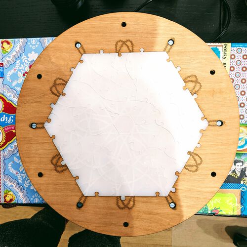 The (first) top layer that holds the puzzle outlines
