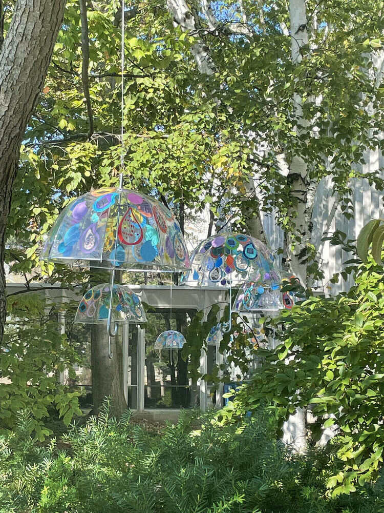 Gratitude Showers umbrellas hanging in trees