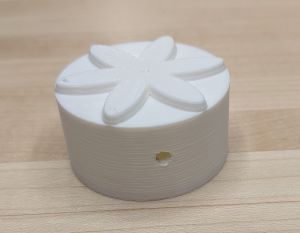 Image of the rattle-like object with a flower top 3d designed and printed by me