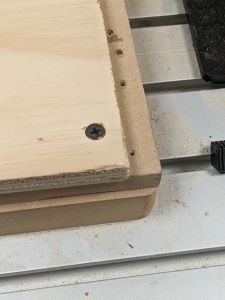 Image of screwing down wood to be cut