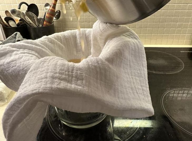Straining through cheesecloth