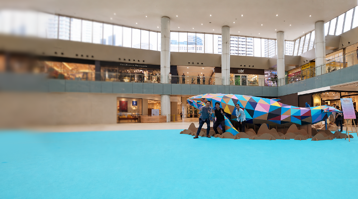 The completed eight-metre cardboard Whale with its makers at Marina Square