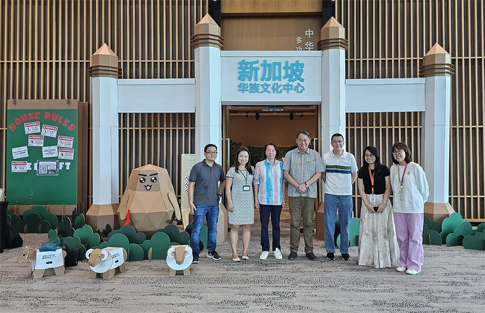 Project collaborators gathered at the completed Whimsical Classroom entrance installation