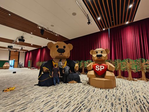 The completed graduation-bear sculptures surrounded by cardboard trees