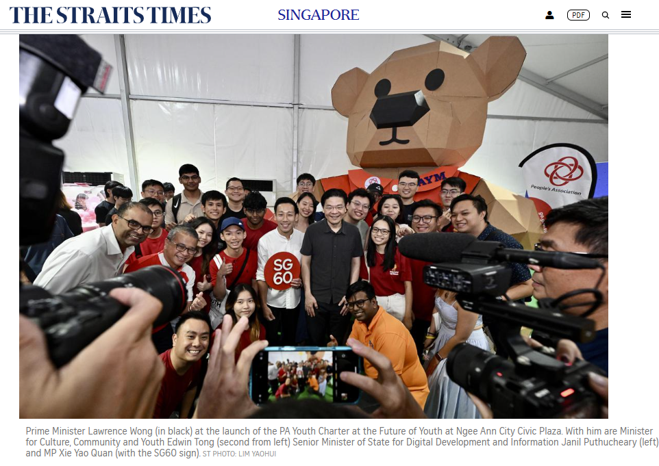 The Straits Times report showing Prime Minister Lawrence Wong meeting students beside the cardboard bear