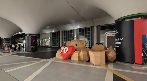 Large cardboard bear body parts staged in a corridor at Ngee Ann City
