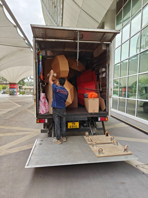 A large bear section being removed from the rear of the delivery truck