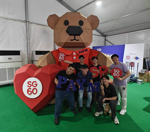 Singapore Polytechnic student team standing with the completed SG60 bear and PAYM display