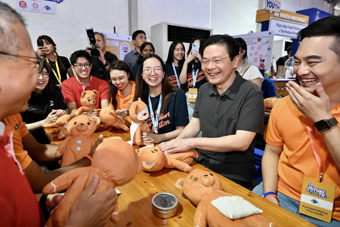 Future YOUth Charter participants sharing their community project with Prime Minister Lawrence Wong