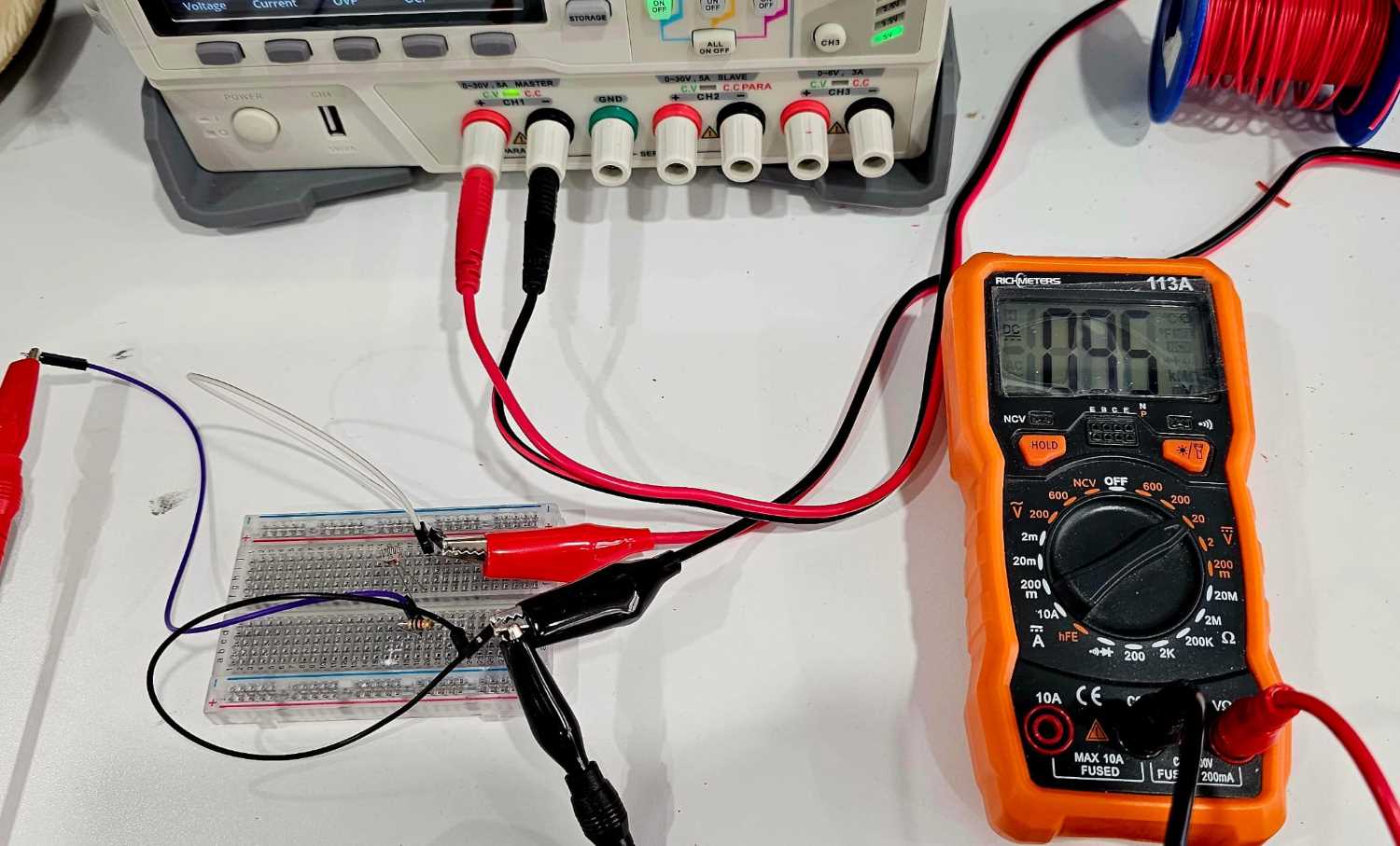 picture of the sensor connected to a micrcontroller board or power source & multimeter