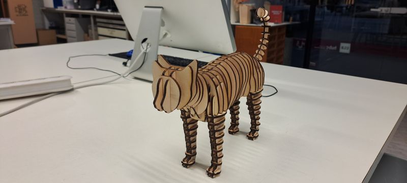 Picture of a 3D wooden cat puzzle assembled.