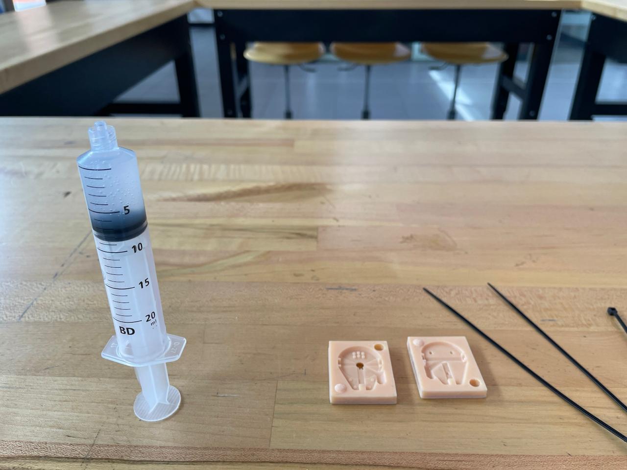 Tools used for casting: molds, syringe, zip ties