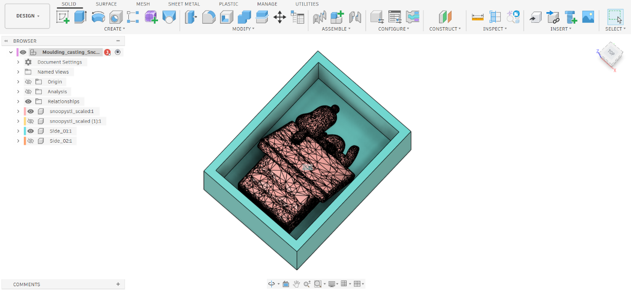 Fusion 360 — Snoopy mesh half (pink/salmon) nested inside the teal mold box container, isometric top view