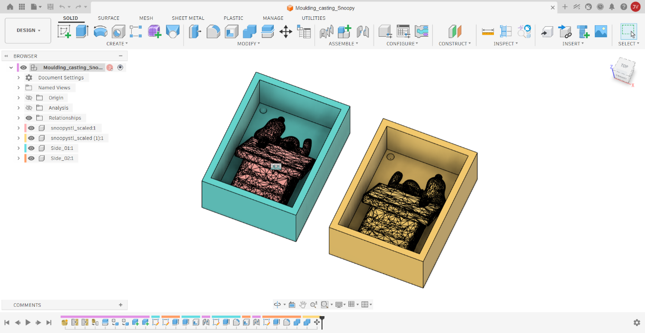 Fusion 360 — Both completed mold matrix halves side by side: Side_01 (teal) and Side_02 (yellow), each with its Snoopy half mesh