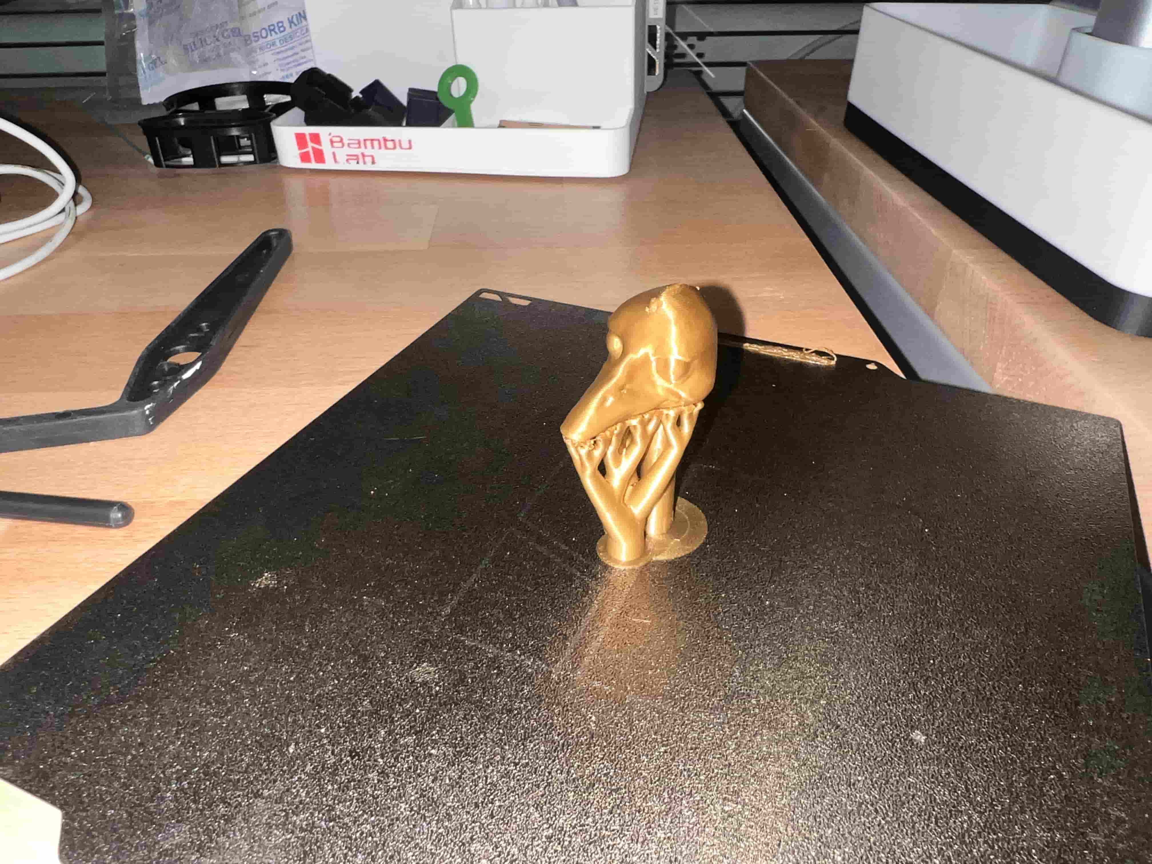 Beige PLA figurine on bed