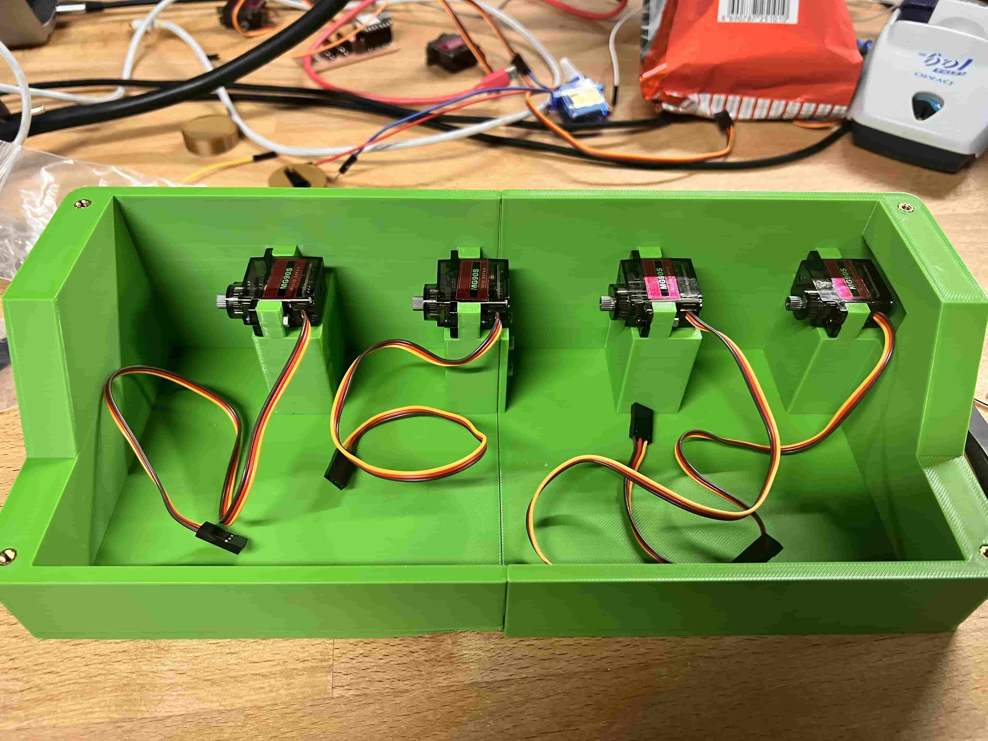 Servos seated in mounts, wiring visible