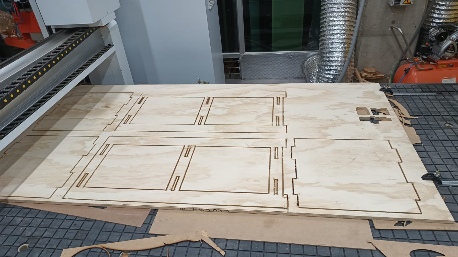 CNC-cut furniture parts laid out and ready for sanding