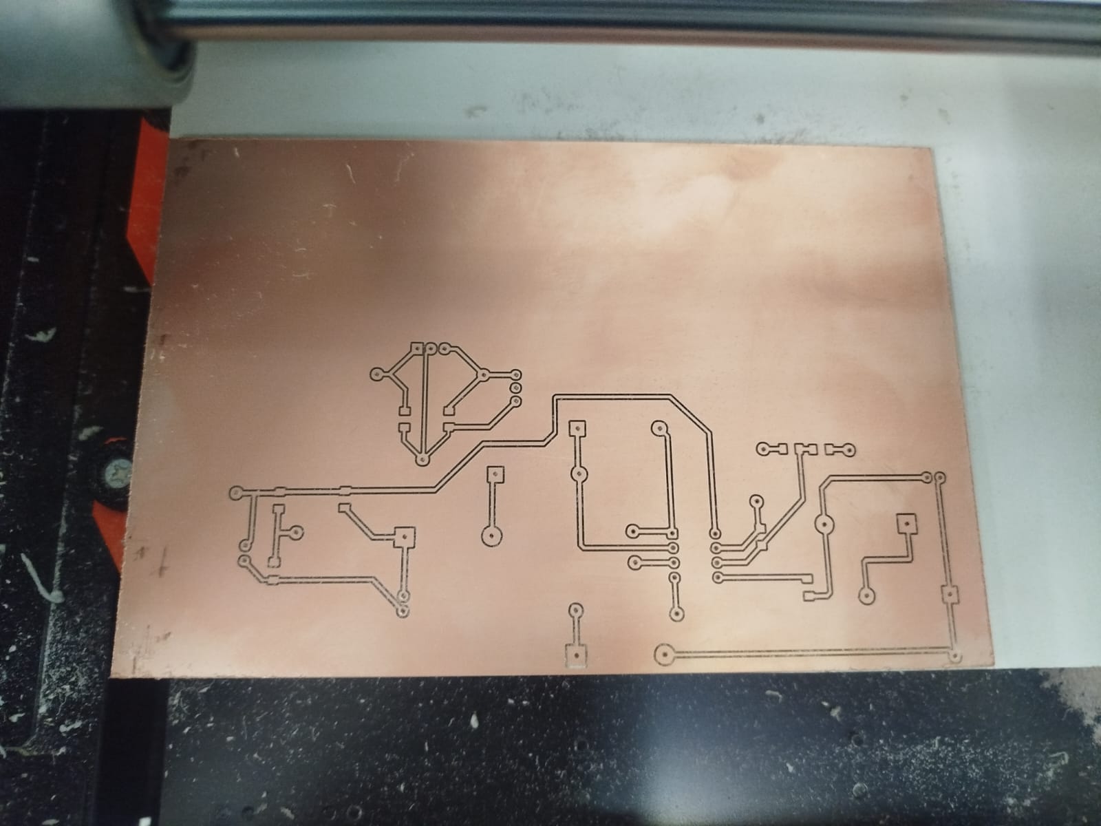 Freshly milled PCB on a copper board, showing traces and pads