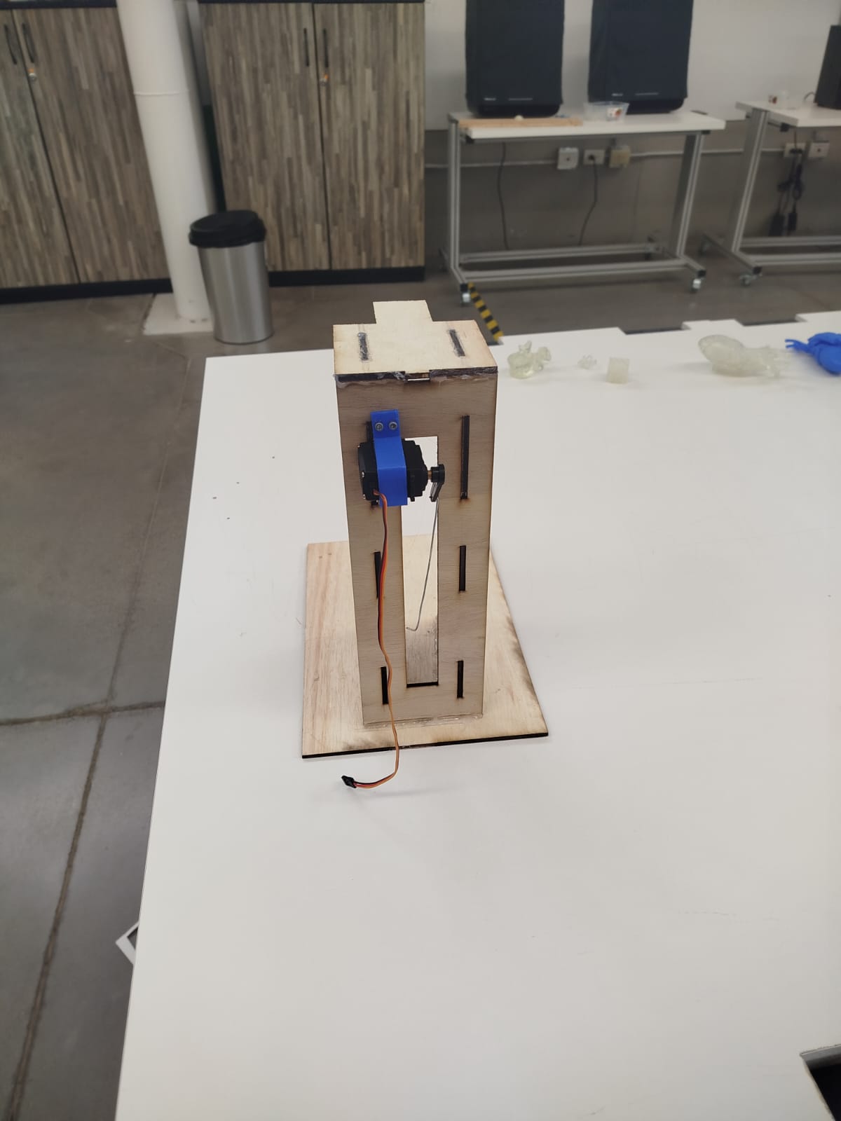 Back view of the puppet stand showing the mounted servo and interlocking design