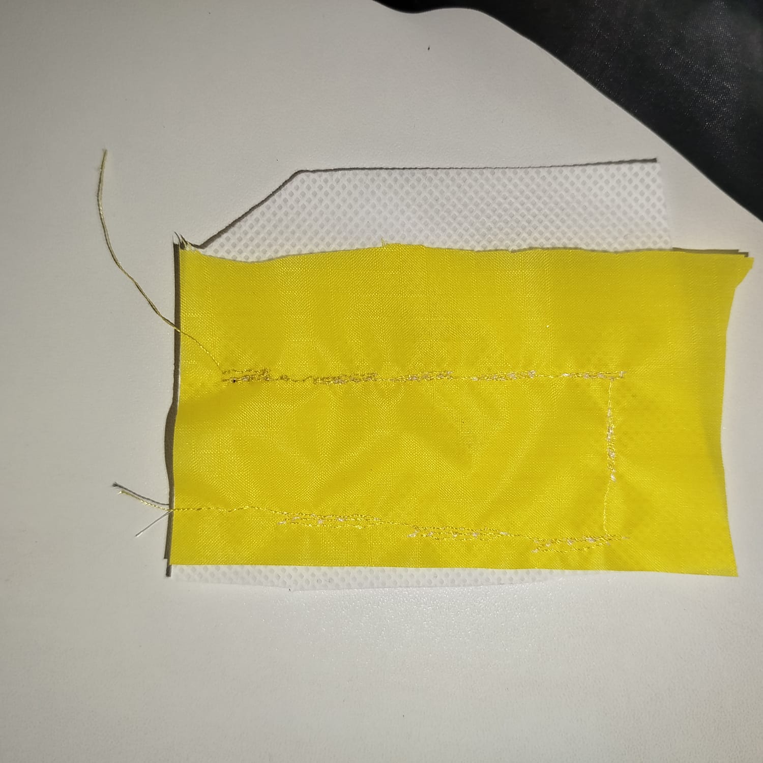 Failed stitch on yellow fabric before adjustment