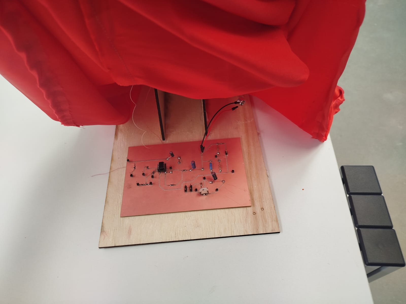 Puppet head with hidden audio circuit underneath red cape