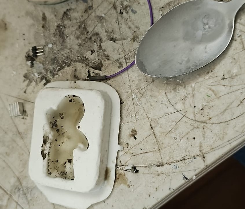 Melting wax with a spoon and lighter
