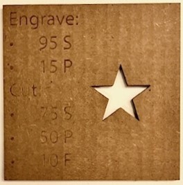 Image of cardboard with laser cutting settings engraved