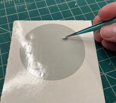 Pulling off piece of vinyl with tweezers