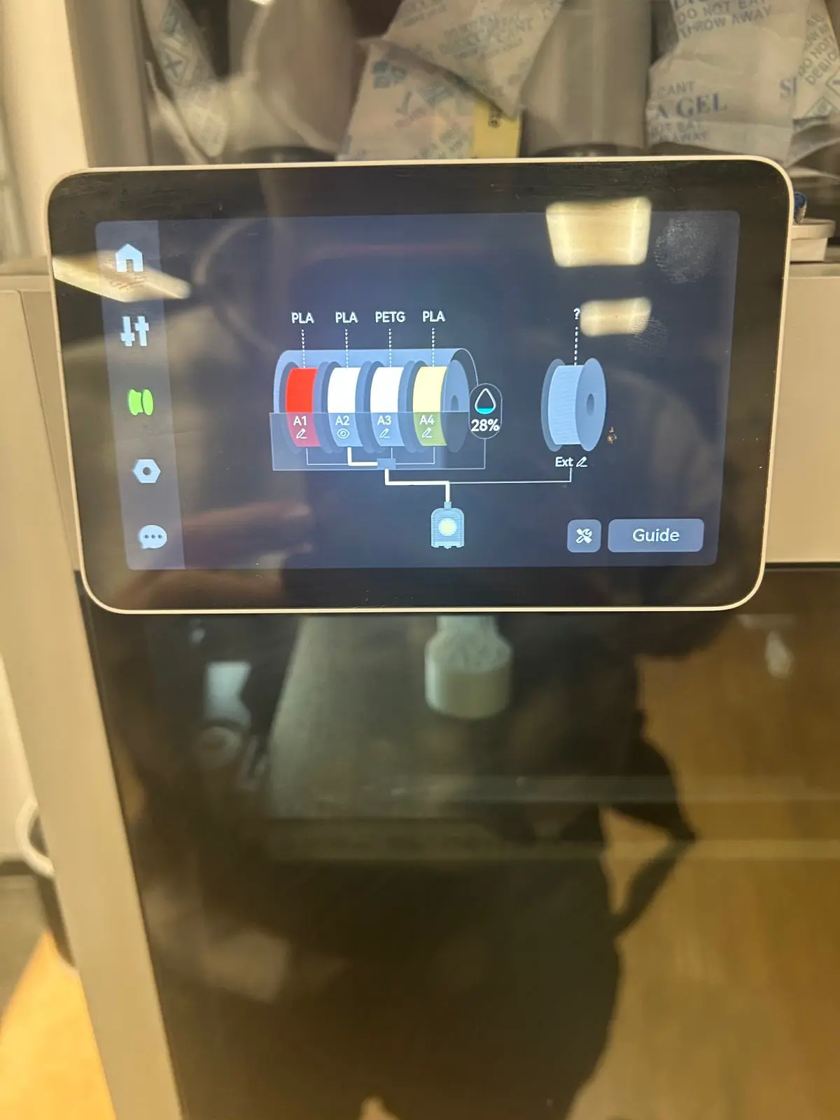 AMS touchscreen showing four filament slots A1–A4 with material types and 28% remaining indicator