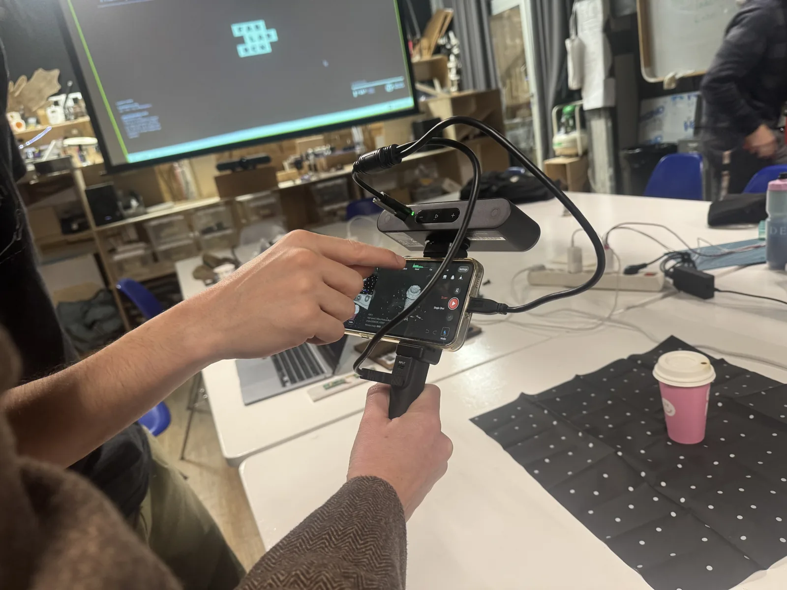 Phone mounted on a holder over a dotted turntable mat as a low cost capture rig