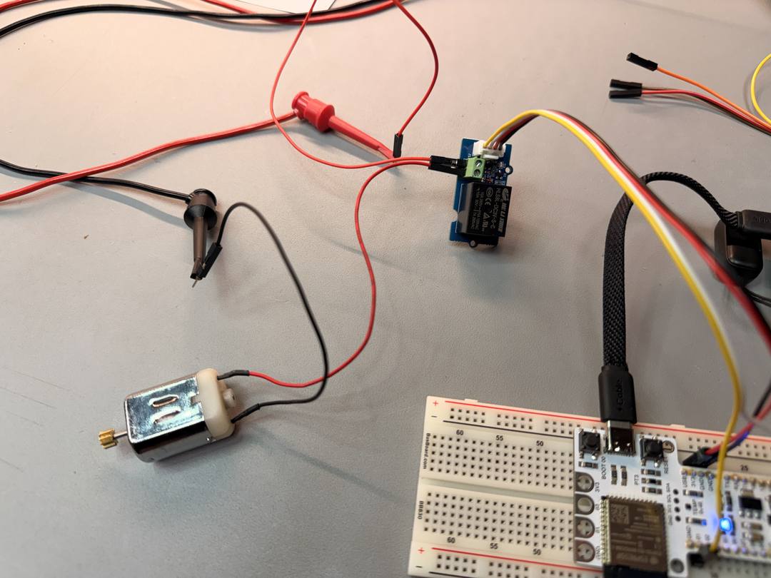 Barduino connected to a Grove relay and DC motor on a breadboard