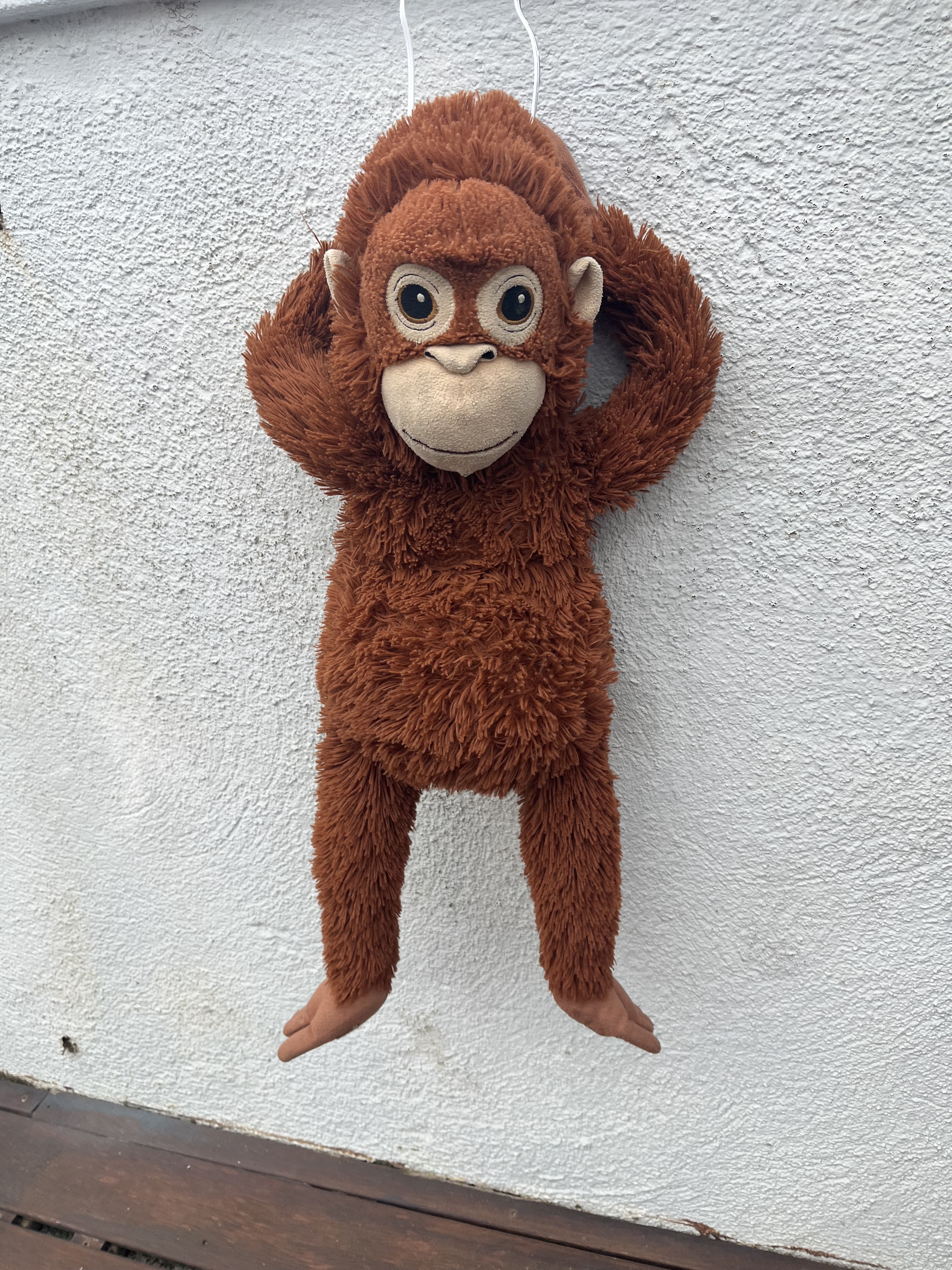 Original object hanging against textured wall