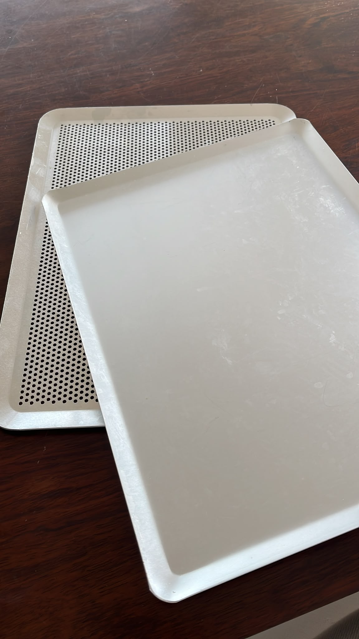 Solid tray and perforated tray comparison