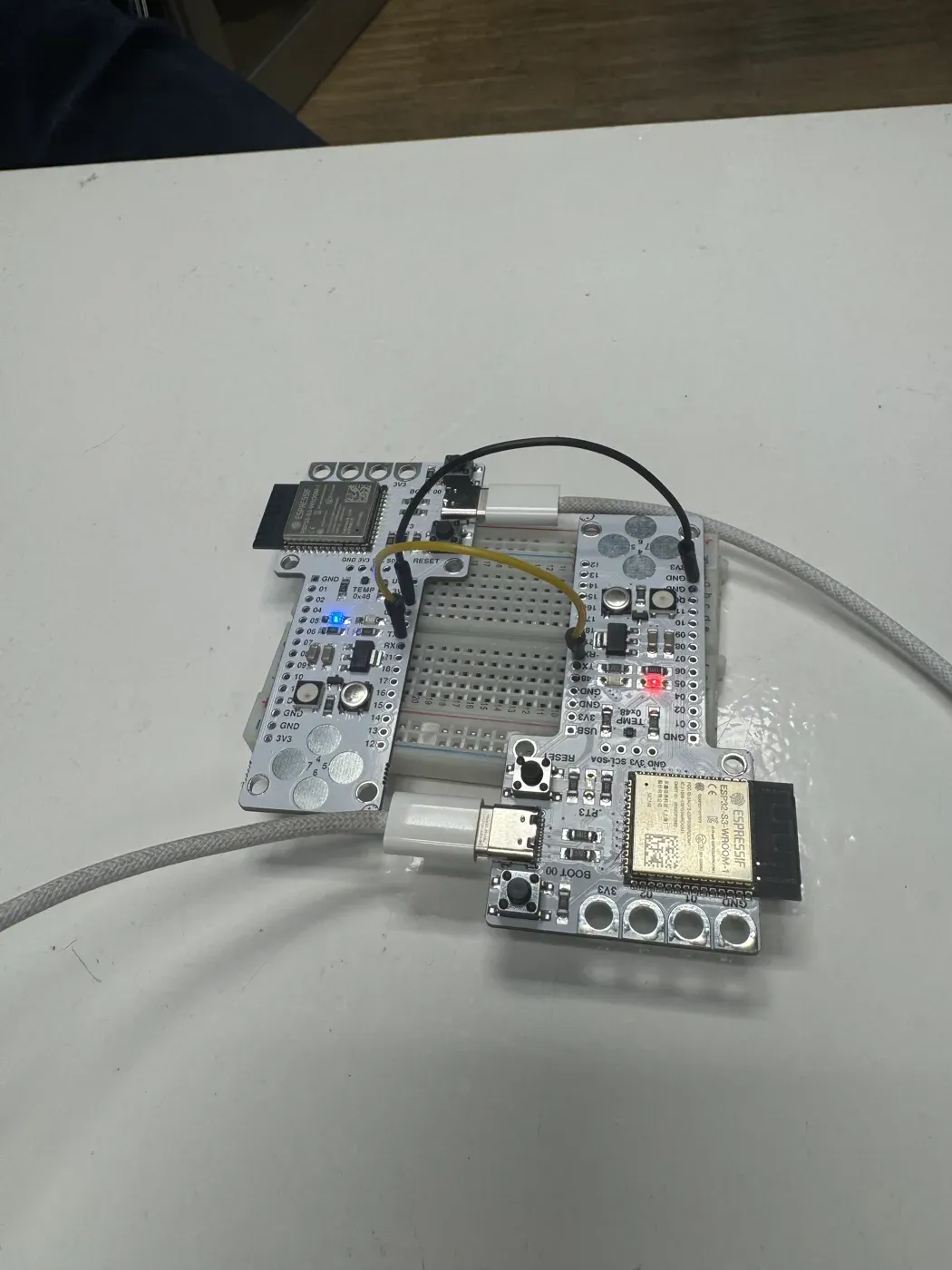 Two Barduino ESP32-S3 boards on a breadboard, wired together with jumper wires for a UART link