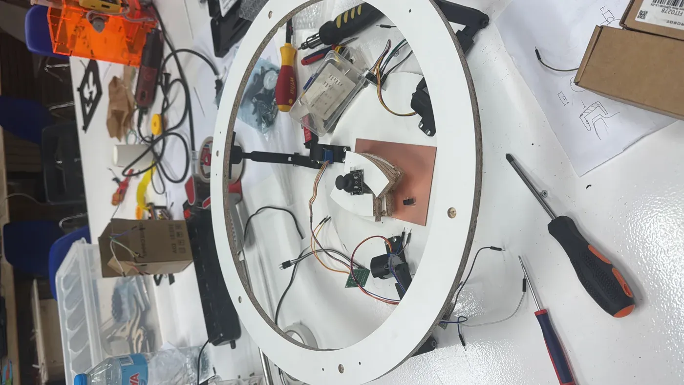 The laser-cut ring assembled into the machine with the joystick and milled shield at the centre