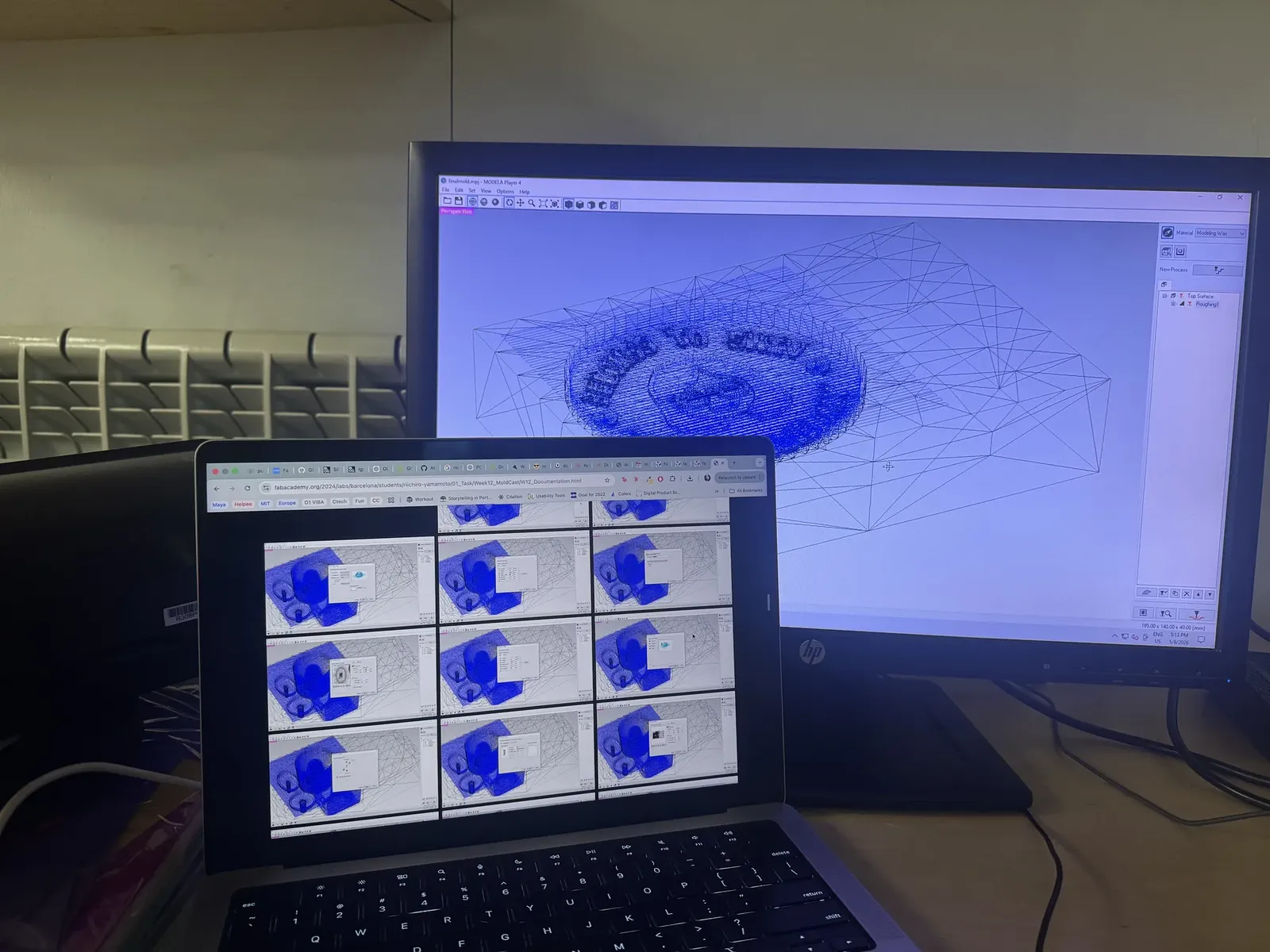 Modela Player 4 open on the monitor showing the avatar mold as a wireframe, reference docs on the laptop below